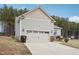 View of the home's exterior, showcasing the garage and side yard at 165 Turlington Rd, Dunn, NC 28334