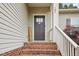 Welcoming front door entrance with brick steps and white railing at 165 Turlington Rd, Dunn, NC 28334