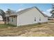 Rear view of tan house with deck, screened porch, and AC unit at 165 Turlington Rd, Dunn, NC 28334