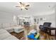 Open living room featuring hardwood floors, a sectional sofa, and a kitchen with island at 165 Turlington Rd, Dunn, NC 28334