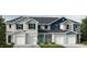 Three-unit townhome building with modern exterior finishes and two-car garages at 1997 Rabbitbrush St, Durham, NC 27703