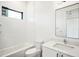 Clean bathroom with white tile, bathtub, and modern vanity at 2119 Brewer St, Raleigh, NC 27608