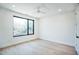 Spacious bedroom with large window, light wood floors, and ceiling fan at 2119 Brewer St, Raleigh, NC 27608