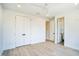 Light-filled bedroom with double doors leading to en-suite bathroom at 2119 Brewer St, Raleigh, NC 27608