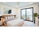 Bright bedroom with balcony access and modern light wood furniture at 2119 Brewer St, Raleigh, NC 27608