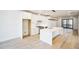 Modern white kitchen with island, stainless steel appliances, and hardwood floors at 2119 Brewer St, Raleigh, NC 27608