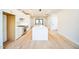 Modern white kitchen with island, hardwood floors and access to backyard at 2119 Brewer St, Raleigh, NC 27608