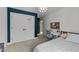 Bright bedroom with built-in desk, double doors, and a comfy bed at 2201 Millbank Village Ct # 101, Raleigh, NC 27610