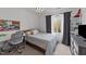 Bright bedroom includes a bed, desk, and plenty of natural light at 2201 Millbank Village Ct # 101, Raleigh, NC 27610