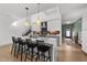 Modern kitchen with white cabinets, marble island, and pendant lighting at 2201 Millbank Village Ct # 101, Raleigh, NC 27610