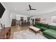 Open living room showcasing a green sectional sofa and views into the kitchen area at 2201 Millbank Village Ct # 101, Raleigh, NC 27610