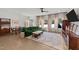 Bright living room with a green sectional sofa, large windows, and hardwood floors at 2201 Millbank Village Ct # 101, Raleigh, NC 27610