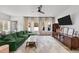 Comfortable living room features a green sofa, hardwood floors, and ample natural light at 2201 Millbank Village Ct # 101, Raleigh, NC 27610