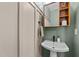 Stylish powder room with pedestal sink and green walls at 2201 Millbank Village Ct # 101, Raleigh, NC 27610
