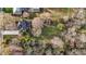 Overhead shot of a home with two sheds, surrounded by green space and mature trees at 228 S Fayetteville St, Liberty, NC 27298