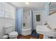 Bathroom with pedestal sink, clawfoot tub, and tiled walls at 228 S Fayetteville St, Liberty, NC 27298