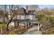 Stunning white two-story home with covered porch, carport, and mature trees at 228 S Fayetteville St, Liberty, NC 27298