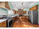 Spacious kitchen featuring wood cabinets, stainless steel appliances, and an eat-in area at 228 S Fayetteville St, Liberty, NC 27298