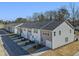 Rear view of townhouses showcasing attached garages at 316 Church St # 38, Wendell, NC 27591