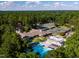 Expansive aerial view of resort-style amenities, including a pool, tennis courts, and lush landscaping at 32602 Archdale, Chapel Hill, NC 27517