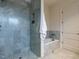 Modern bathroom with tiled walk-in shower and separate soaking tub, creating a spa-like retreat at 32602 Archdale, Chapel Hill, NC 27517
