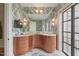 Gorgeous bathroom featuring marble-style walls, a curved wood vanity and outdoor views at 32602 Archdale, Chapel Hill, NC 27517