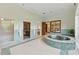Spacious bathroom with sauna, shower, jacuzzi tub, and tiled accents, creating a spa-like retreat at 32602 Archdale, Chapel Hill, NC 27517
