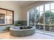 Bathroom showcasing a soaking tub with a pebble base, set beneath a large picture window at 32602 Archdale, Chapel Hill, NC 27517
