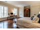 Inviting bedroom featuring hardwood floors, large windows, and a comfortable workspace at 32602 Archdale, Chapel Hill, NC 27517