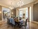 Formal dining room with elegant chandeliers, decorative columns, and access to more rooms at 32602 Archdale, Chapel Hill, NC 27517