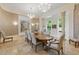 Elegant dining room with chandeliers, decorative columns, and large windows at 32602 Archdale, Chapel Hill, NC 27517
