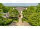 Stately two-story home with manicured landscaping, mature trees, and beautiful hardscape pathway at 32602 Archdale, Chapel Hill, NC 27517