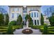 Stunning exterior elevation of a large home with manicured landscaping and mature trees at 32602 Archdale, Chapel Hill, NC 27517