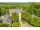 Two-story home with manicured landscaping, mature trees, and beautiful hardscape pathway at 32602 Archdale, Chapel Hill, NC 27517