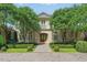 Elegant stone mansion with a symmetrical facade, manicured lawn, and mature trees at 32602 Archdale, Chapel Hill, NC 27517