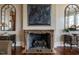 Elegant fireplace with marble surround flanked by custom cabinetry makes a great focal point at 32602 Archdale, Chapel Hill, NC 27517