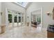Elegant foyer features a skylight, travertine floors, and access to a sun-drenched living room through an arched entryway at 32602 Archdale, Chapel Hill, NC 27517