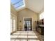 Foyer with skylight, stone floors, wet bar and French doors with view to rooms inside and out at 32602 Archdale, Chapel Hill, NC 27517