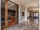 Elegant foyer with stone floors and custom wood doors leading to an inviting library at 32602 Archdale, Chapel Hill, NC 27517