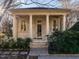 Elegant portico with stone columns and manicured landscaping, creating a welcoming entrance at 32602 Archdale, Chapel Hill, NC 27517