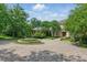 Breathtaking front yard featuring a circular driveway, manicured landscaping, and mature trees at 32602 Archdale, Chapel Hill, NC 27517