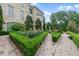 Beautifully landscaped gardens surround this stone mansion on a sunny day at 32602 Archdale, Chapel Hill, NC 27517