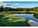 Expansive aerial view of a picturesque golf course with a pond, sand traps, and lush green grass at 32602 Archdale, Chapel Hill, NC 27517