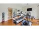 Well-equipped home gym featuring a treadmill, elliptical, weights, and a mirrored wall reflecting the bathroom and additional equipment at 32602 Archdale, Chapel Hill, NC 27517