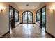 Hallway with arched entry, stone floors, and sidelight windows leading to outdoor views at 32602 Archdale, Chapel Hill, NC 27517