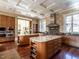 Open kitchen featuring two islands, custom cabinetry, and stainless steel appliances at 32602 Archdale, Chapel Hill, NC 27517