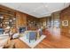Beautiful library showcasing custom bookshelves, a fireplace, hardwood floors, and comfortable seating arrangements at 32602 Archdale, Chapel Hill, NC 27517