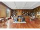 Spacious library features rich wood paneling, custom bookshelves, and a cozy fireplace, perfect for reading and relaxing at 32602 Archdale, Chapel Hill, NC 27517