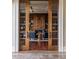 Library features wooden sliding doors, custom bookshelves, and comfortable seating at 32602 Archdale, Chapel Hill, NC 27517