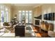 Comfortable living room with fireplace, French doors to the backyard, hardwood floors and neutral colors at 32602 Archdale, Chapel Hill, NC 27517